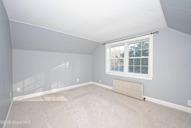 bonus room with vaulted ceiling, radiator, carpet, and baseboards