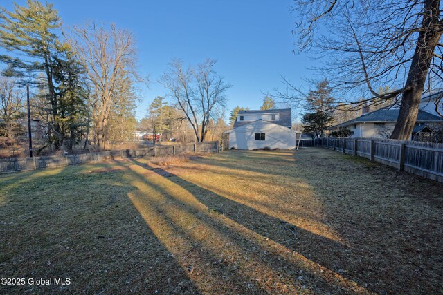 view of yard featuring an outdoor structure and a fenced backyard