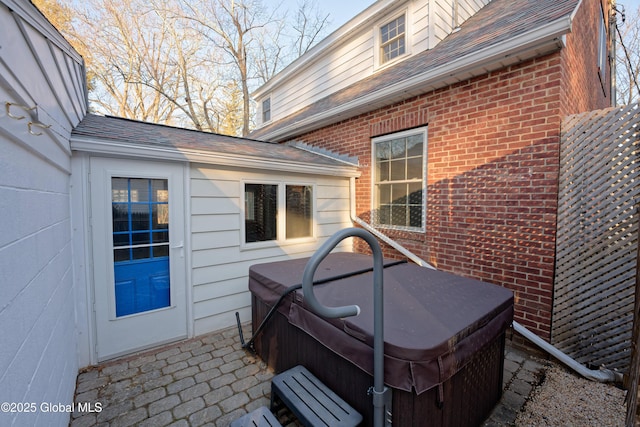 view of patio / terrace with a hot tub