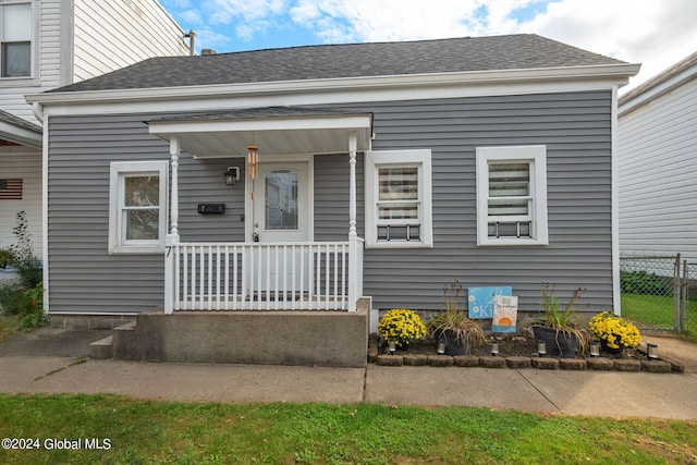 view of front of home with a porch and a shingled roof