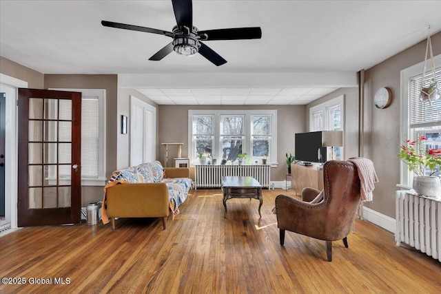 living area featuring radiator and wood finished floors