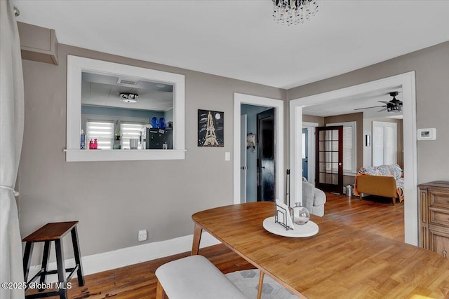 dining space featuring baseboards, dark wood finished floors, and a ceiling fan