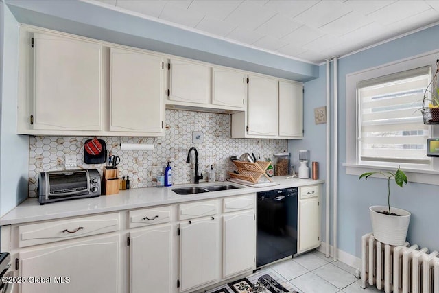 kitchen with radiator heating unit, black dishwasher, decorative backsplash, white cabinetry, and a sink