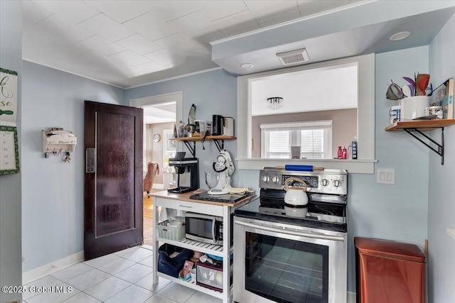 kitchen with visible vents, open shelves, stainless steel appliances, light tile patterned floors, and baseboards