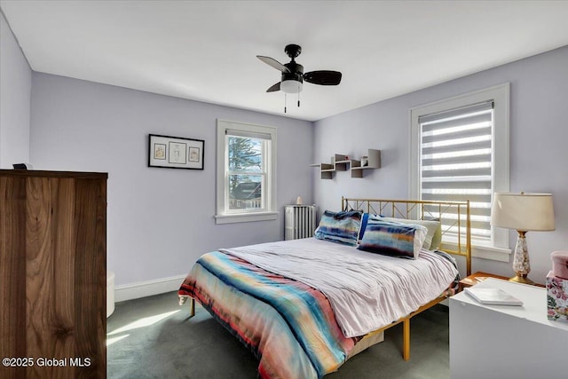 carpeted bedroom with a ceiling fan and baseboards