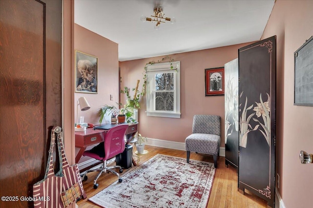 home office with baseboards and wood finished floors