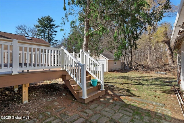 view of yard featuring an outbuilding, a shed, and a wooden deck