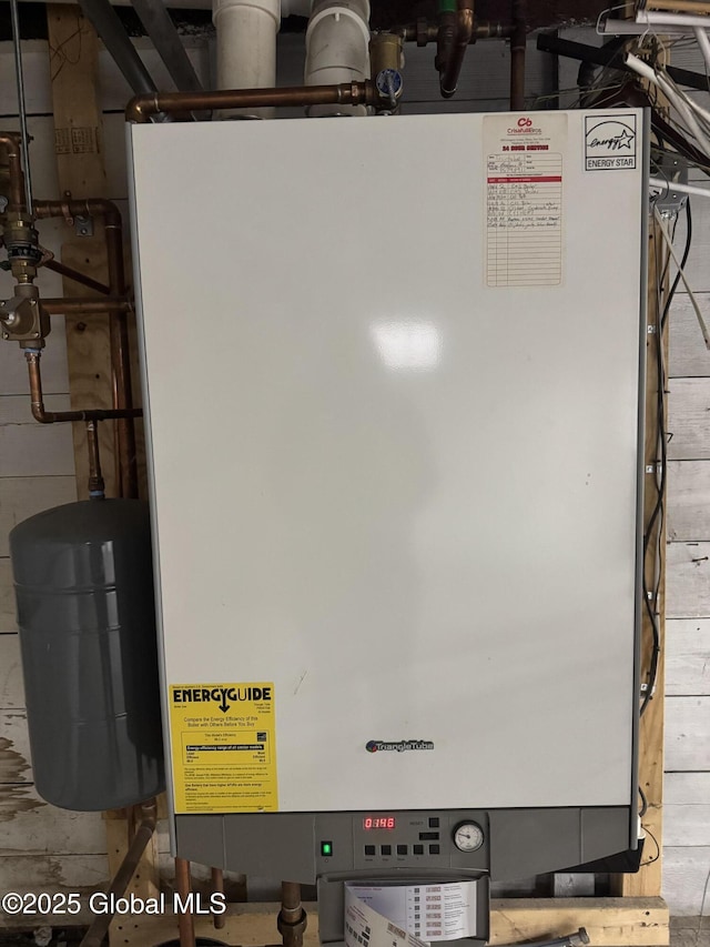 utility room featuring tankless water heater