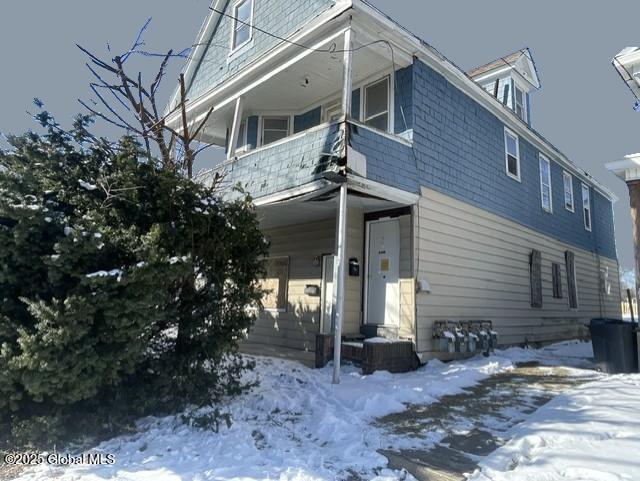 view of front of house featuring a garage and a balcony