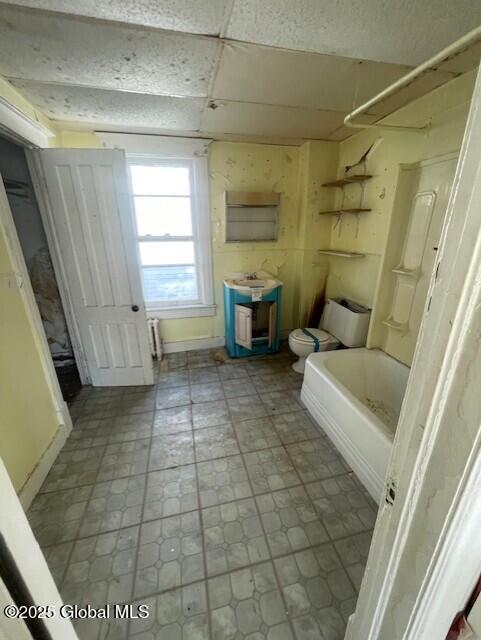 bathroom with toilet and bathing tub / shower combination