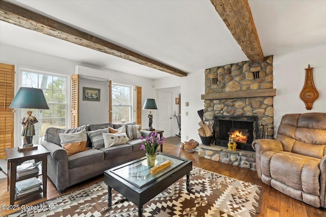 155 Andrews Rd, Carlisle, NY 12160 - living area featuring hardwood / wood-style flooring, beamed ceiling, a fireplace, and a wall mounted AC