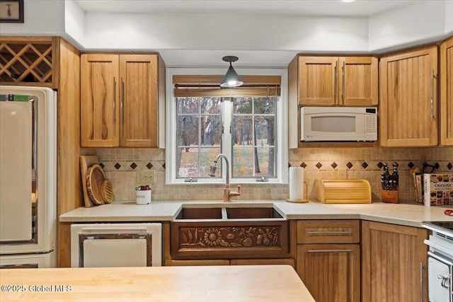 155 Andrews Rd, Carlisle, NY 12160 - kitchen featuring dishwashing machine, white microwave, a sink, light countertops, and backsplash