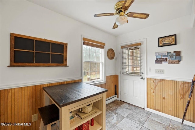 155 Andrews Rd, Carlisle, NY 12160 - interior space with a wainscoted wall, baseboard heating, ceiling fan, and wooden walls