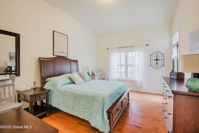 bedroom with light wood-type flooring and baseboards