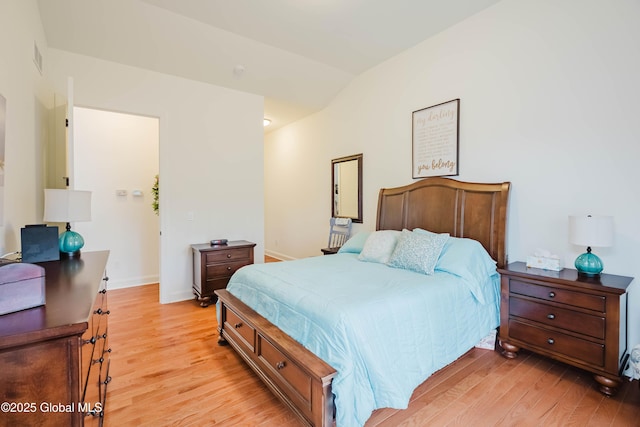 bedroom with light wood-style flooring and baseboards