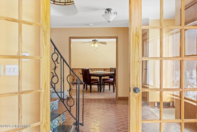 hallway featuring ornamental molding and french doors