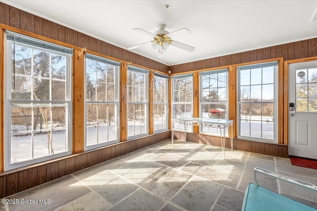 unfurnished sunroom with ceiling fan