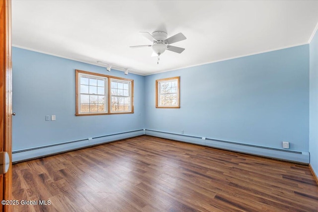 spare room with a baseboard radiator, crown molding, ceiling fan, and wood finished floors