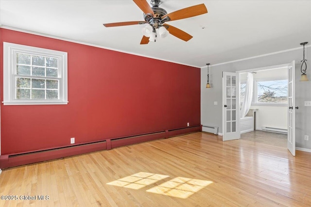 unfurnished room with a baseboard heating unit, light wood finished floors, and ornamental molding