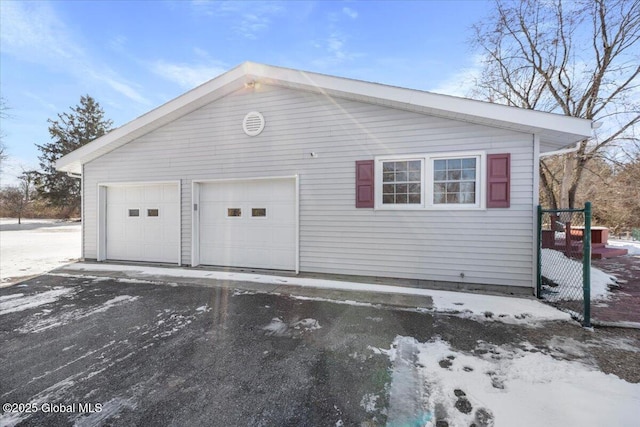 snow covered garage with a garage