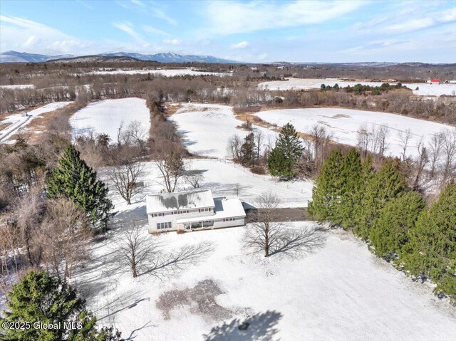 snowy aerial view featuring a mountain view