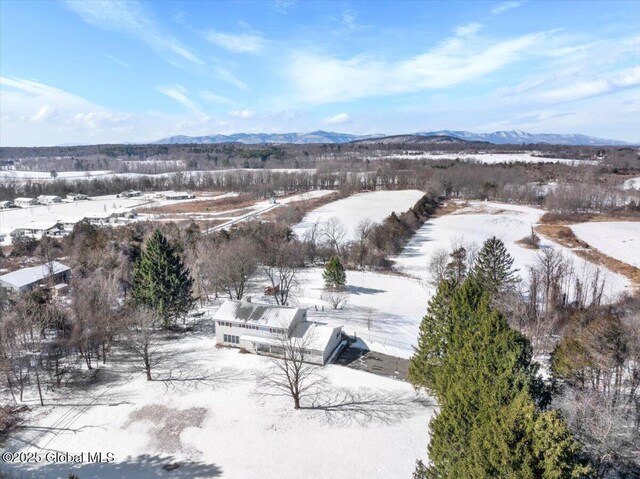 snowy aerial view with a mountain view