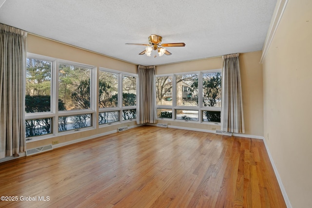 interior space with plenty of natural light, visible vents, and ceiling fan