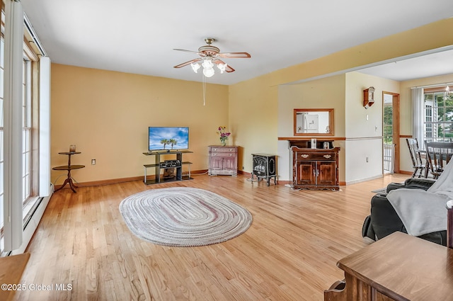 18 Johnson Ln, Poestenkill, NY 12018 - living room with light wood finished floors, ceiling fan, and a baseboard heating unit