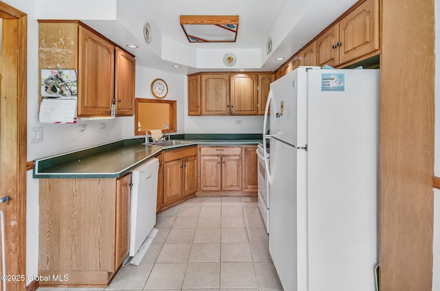 18 Johnson Ln, Poestenkill, NY 12018 - kitchen with white appliances, light tile patterned floors, brown cabinets, dark countertops, and a raised ceiling