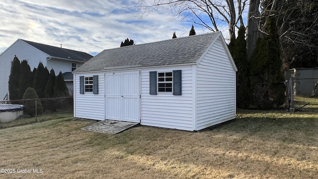 view of shed featuring fence