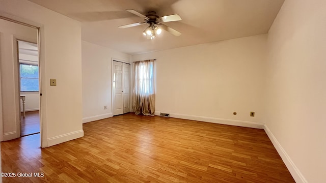 unfurnished bedroom featuring a closet, light wood-type flooring, visible vents, and baseboards