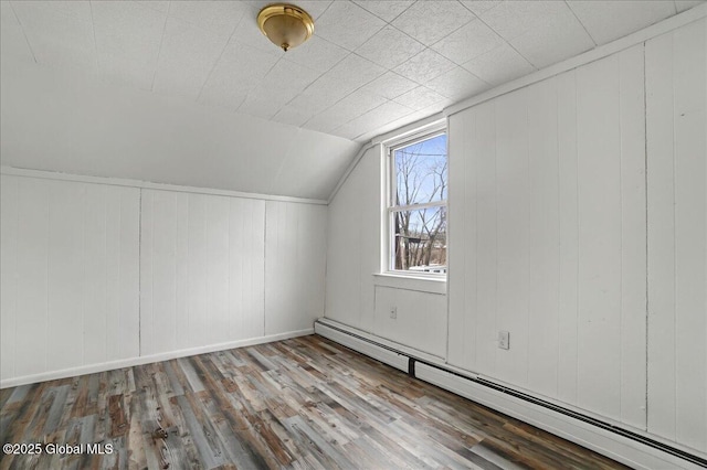 bonus room featuring a baseboard radiator, baseboards, wood finished floors, and vaulted ceiling
