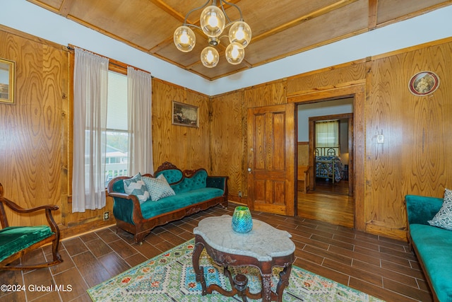 living area with wood tiled floor, wooden walls, and a notable chandelier