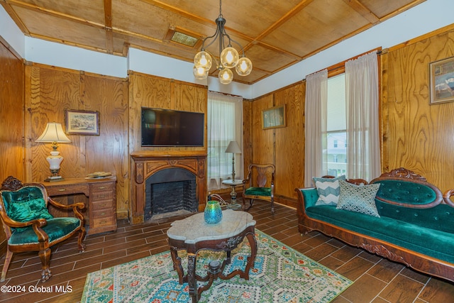 living room featuring a chandelier, wood tiled floor, a fireplace, and wooden walls