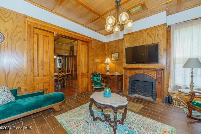 living area featuring a chandelier, wood finish floors, a fireplace, and visible vents