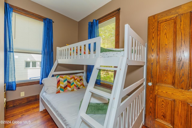 bedroom with baseboards and wood finished floors