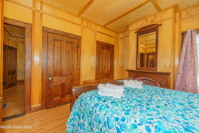 bedroom with light wood-style floors and visible vents