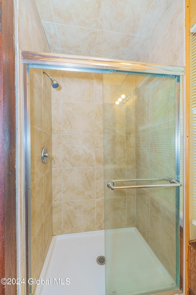 full bath with a shower stall