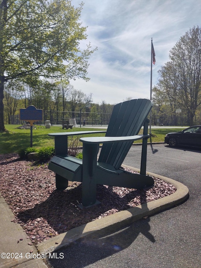 view of community featuring fence and a lawn