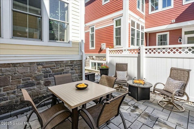 view of patio with outdoor dining space and fence