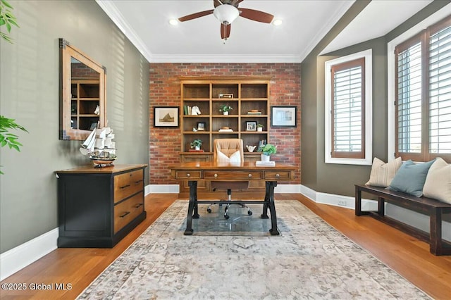 office area featuring plenty of natural light, light wood-type flooring, and ornamental molding