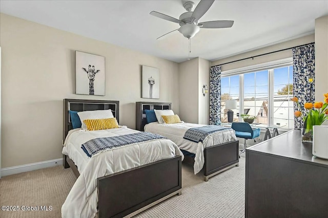 bedroom featuring light carpet, ceiling fan, and baseboards