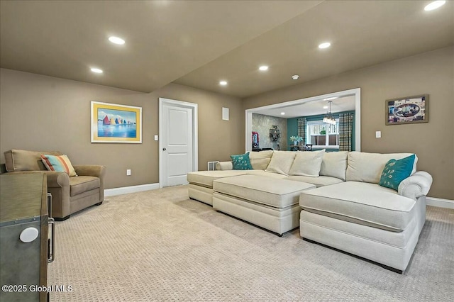 living area featuring light carpet, recessed lighting, and baseboards