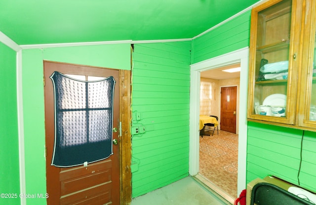 entryway featuring wooden walls