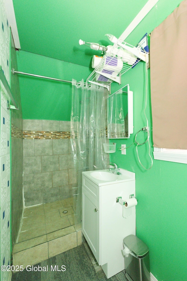 bathroom featuring vanity and a tile shower