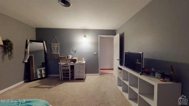 carpeted office space with visible vents and baseboards