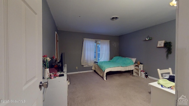 bedroom with carpet floors, visible vents, and baseboards