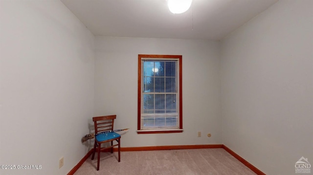 spare room with light carpet and baseboards