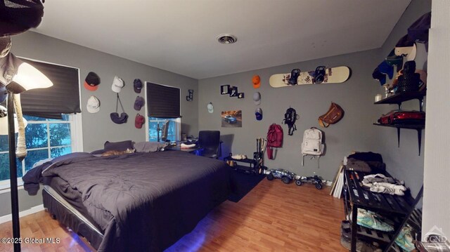 bedroom featuring visible vents and wood finished floors