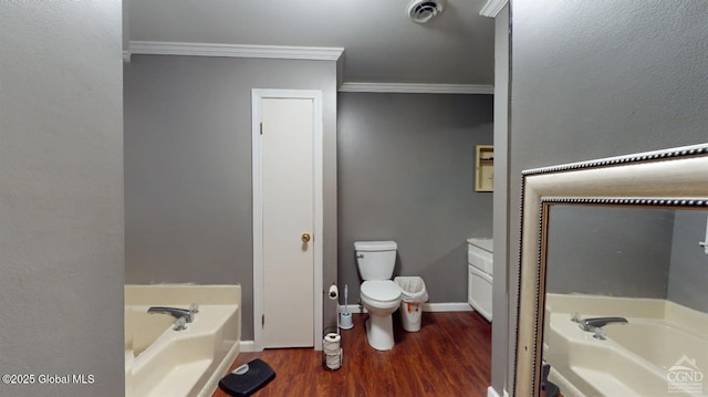 full bathroom featuring visible vents, toilet, ornamental molding, wood finished floors, and a garden tub